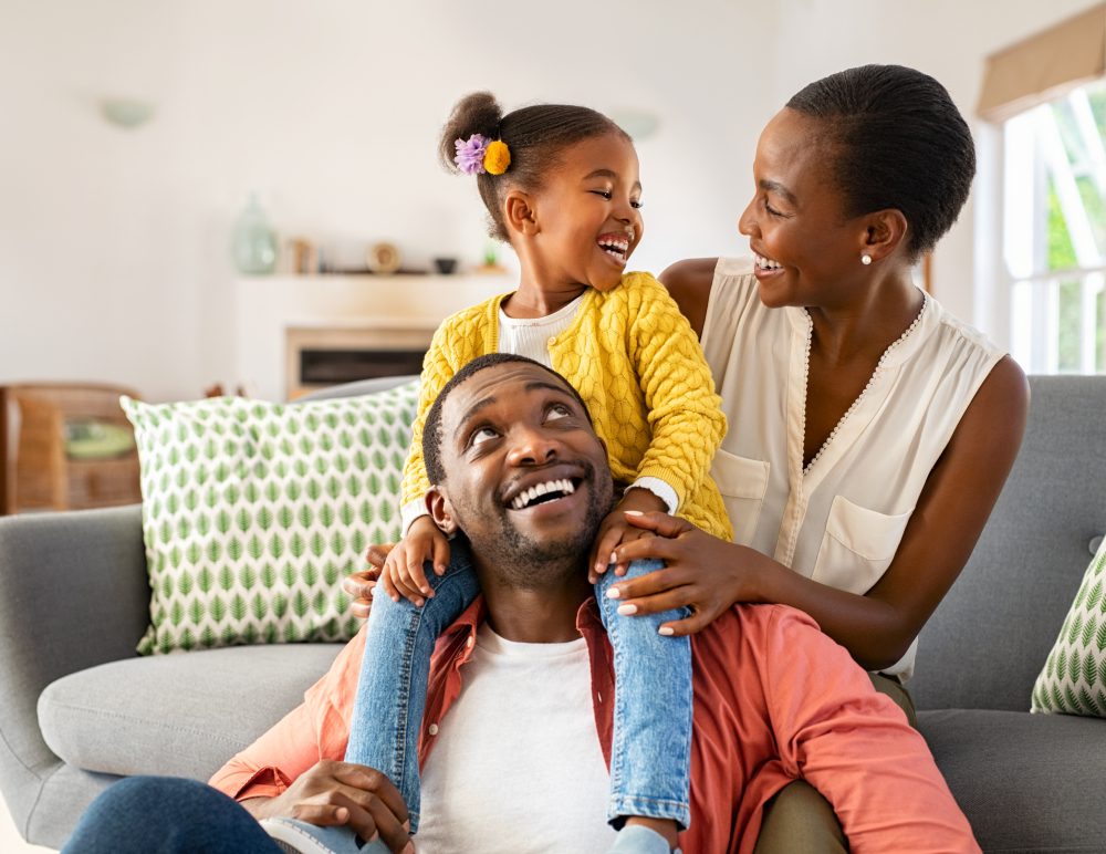 Happy family smiling in living room together.