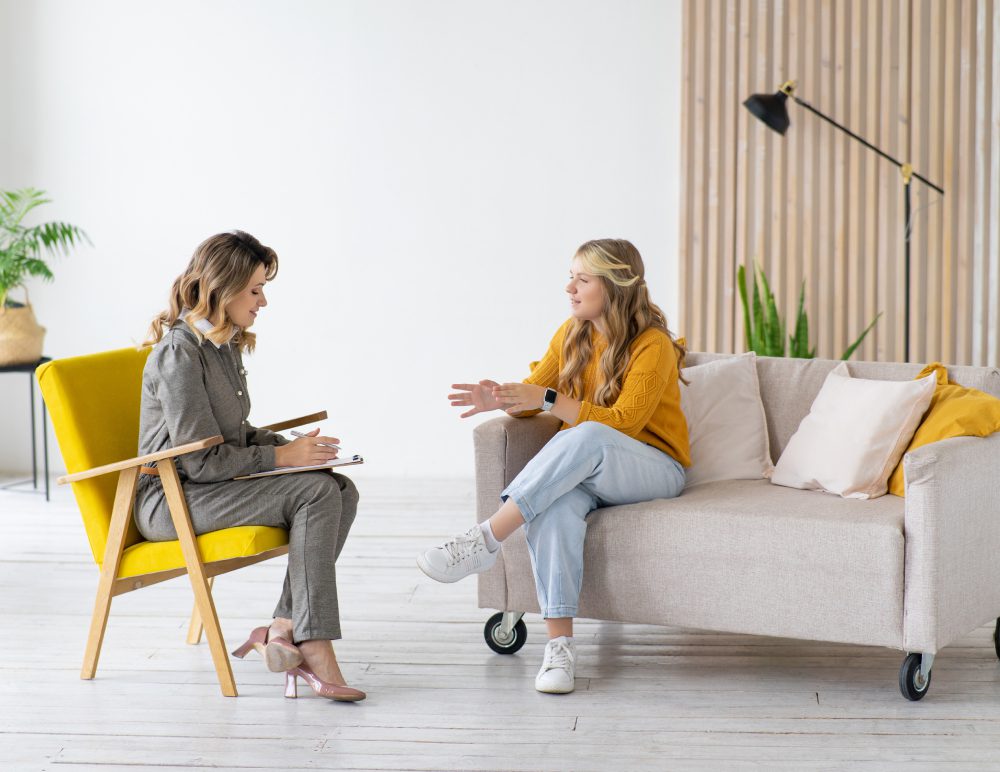 Two women having a conversation indoors.