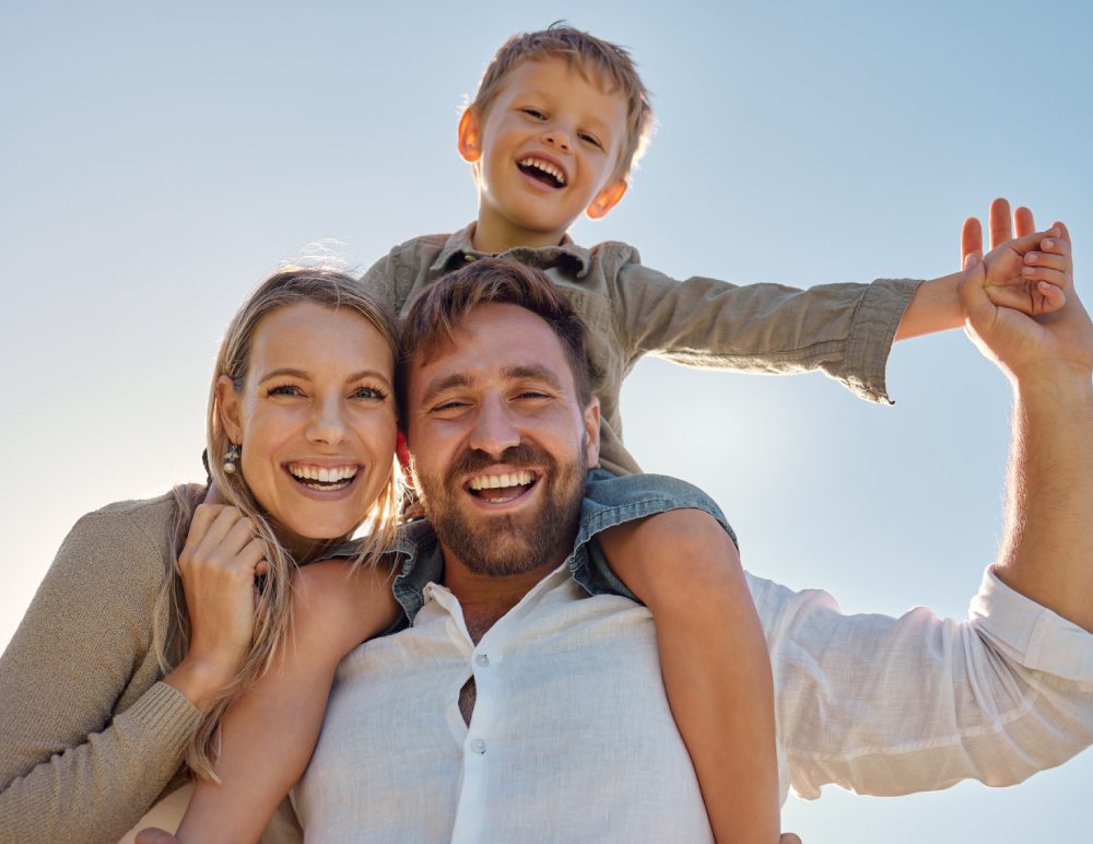 Smiling family enjoying sunny day together.