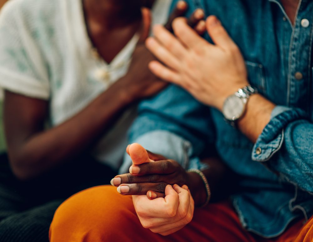 Two people holding hands, close-up view.