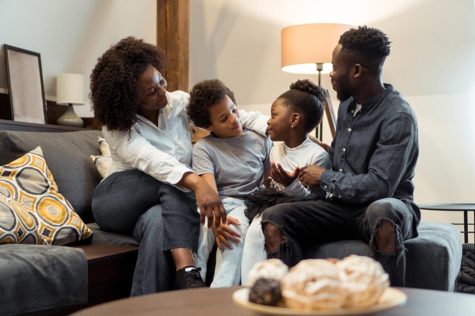 Family talking together on a cozy couch.