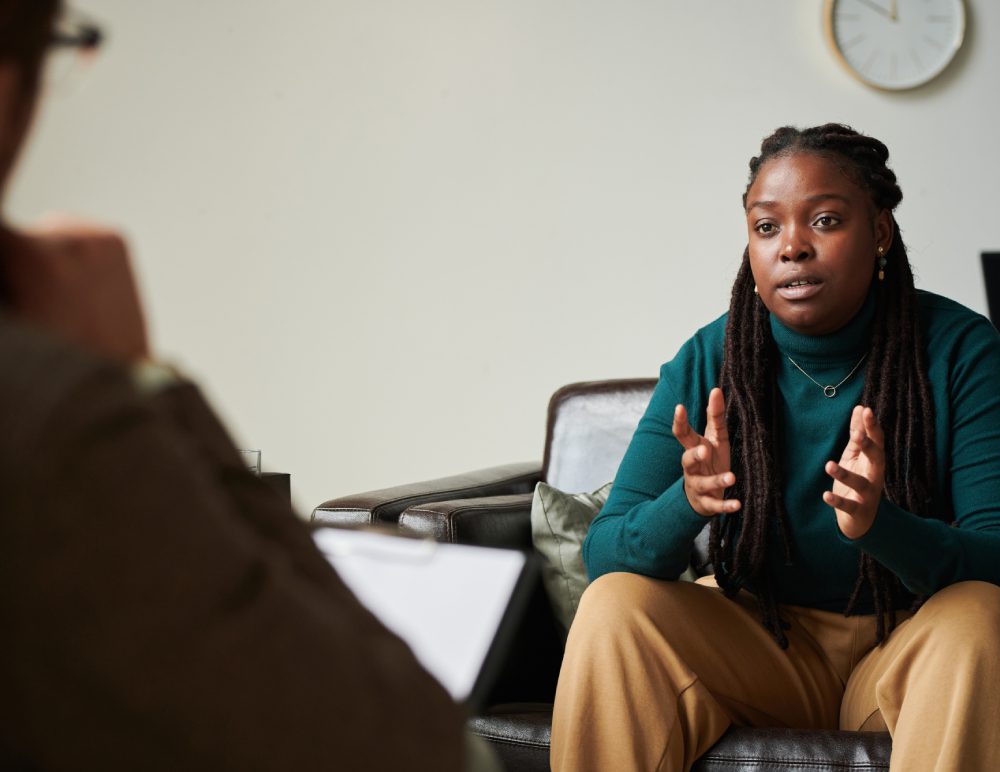 Woman speaking in a therapy session.