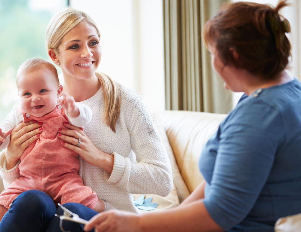 Mother and baby with a professional woman.