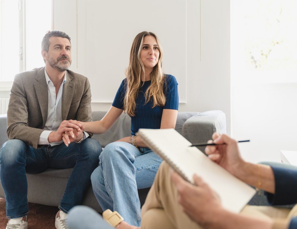 Couple in therapy session with counselor.