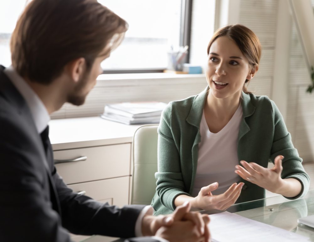 A woman and man are talking to each other.
